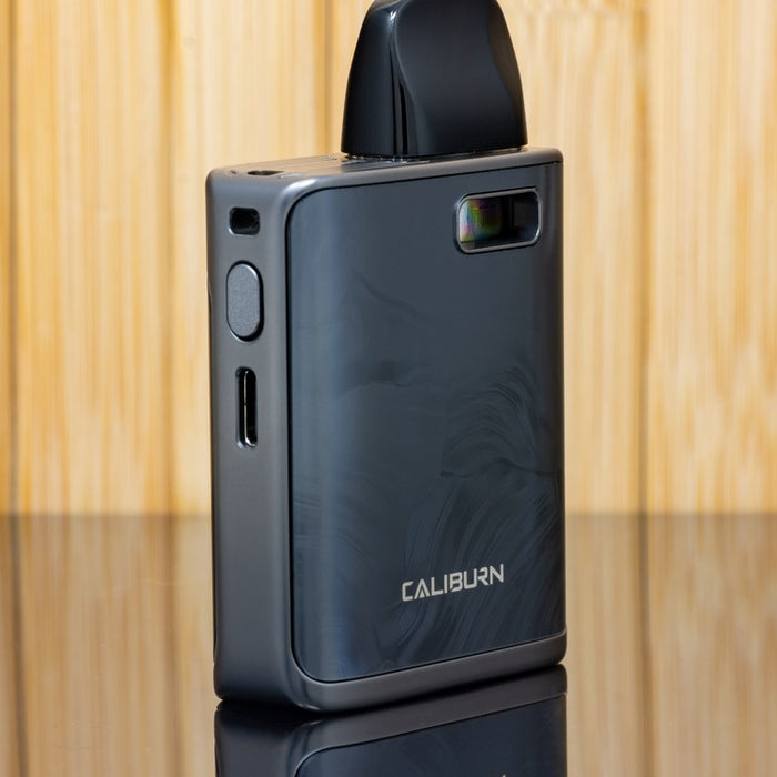 The UWell Caliburn G3 Pro KOKO in black sitting on reflective surface outside