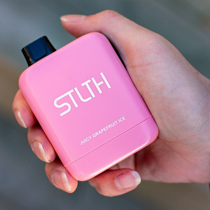 Person holding pink STLTH Titan Max vape in hand