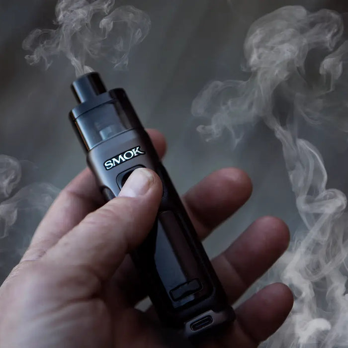 SMOK RPM 5 in hand with smoke in the background