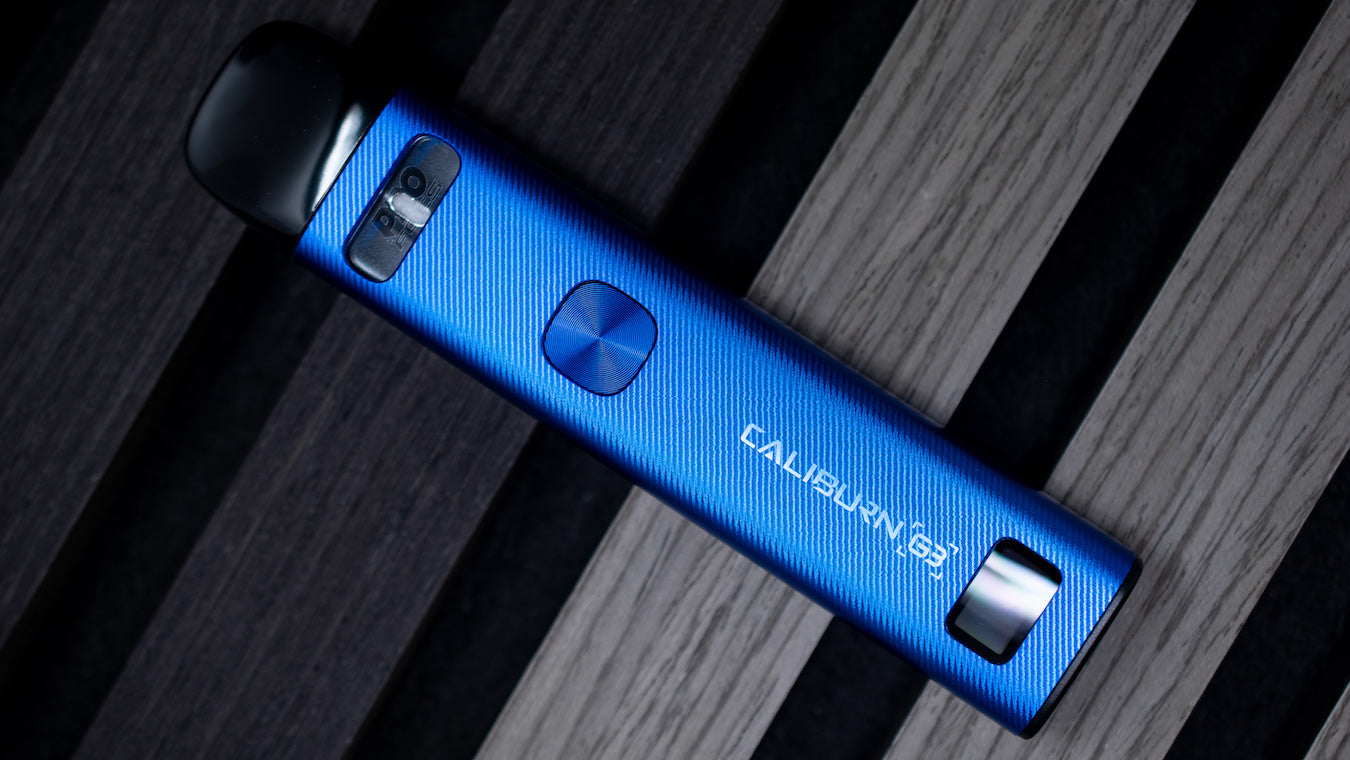 Cobalt blue UWell Caliburn G3 vape device lying on wood planks