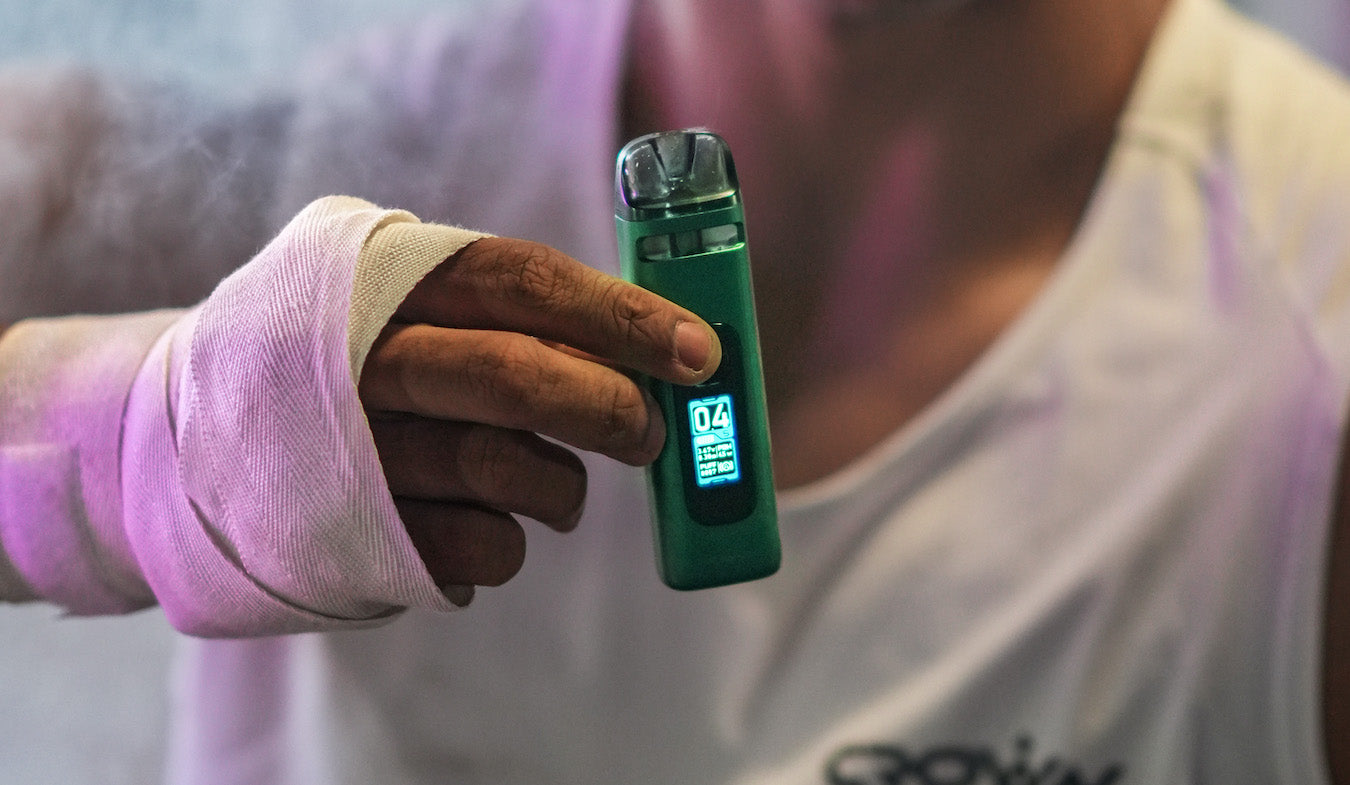 Man holding a green UWell Crown X vape device