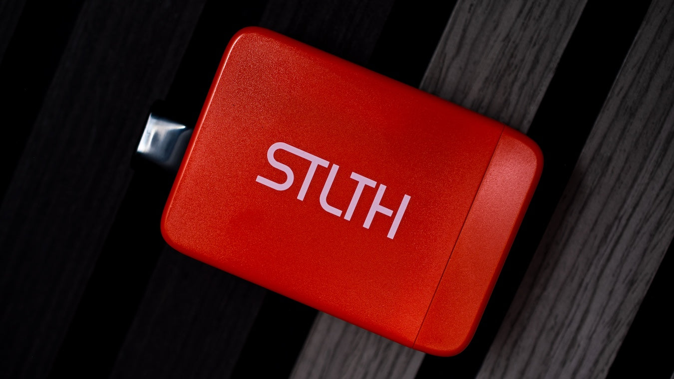 STLTH Titan Pro disposable lying on a wooden surface