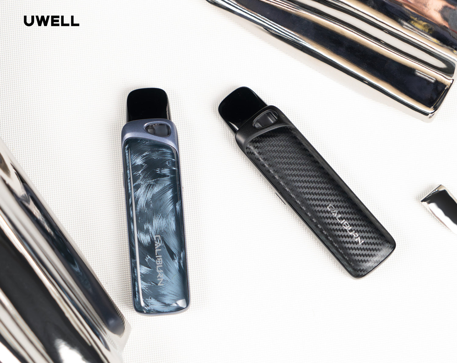 Two UWell Caliburn G4 Pro devices lying on side after use