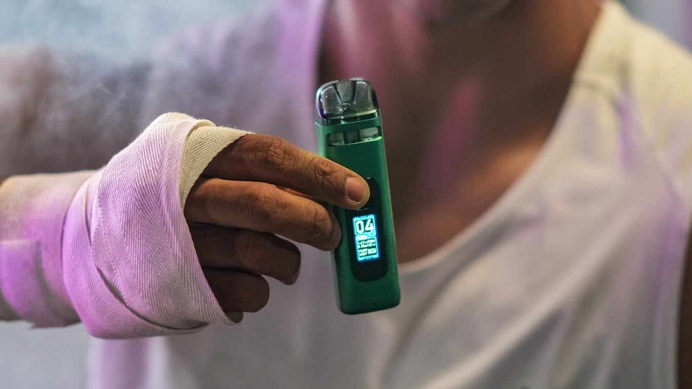 Man holding UWell Crown X vape device in Crown X Green
