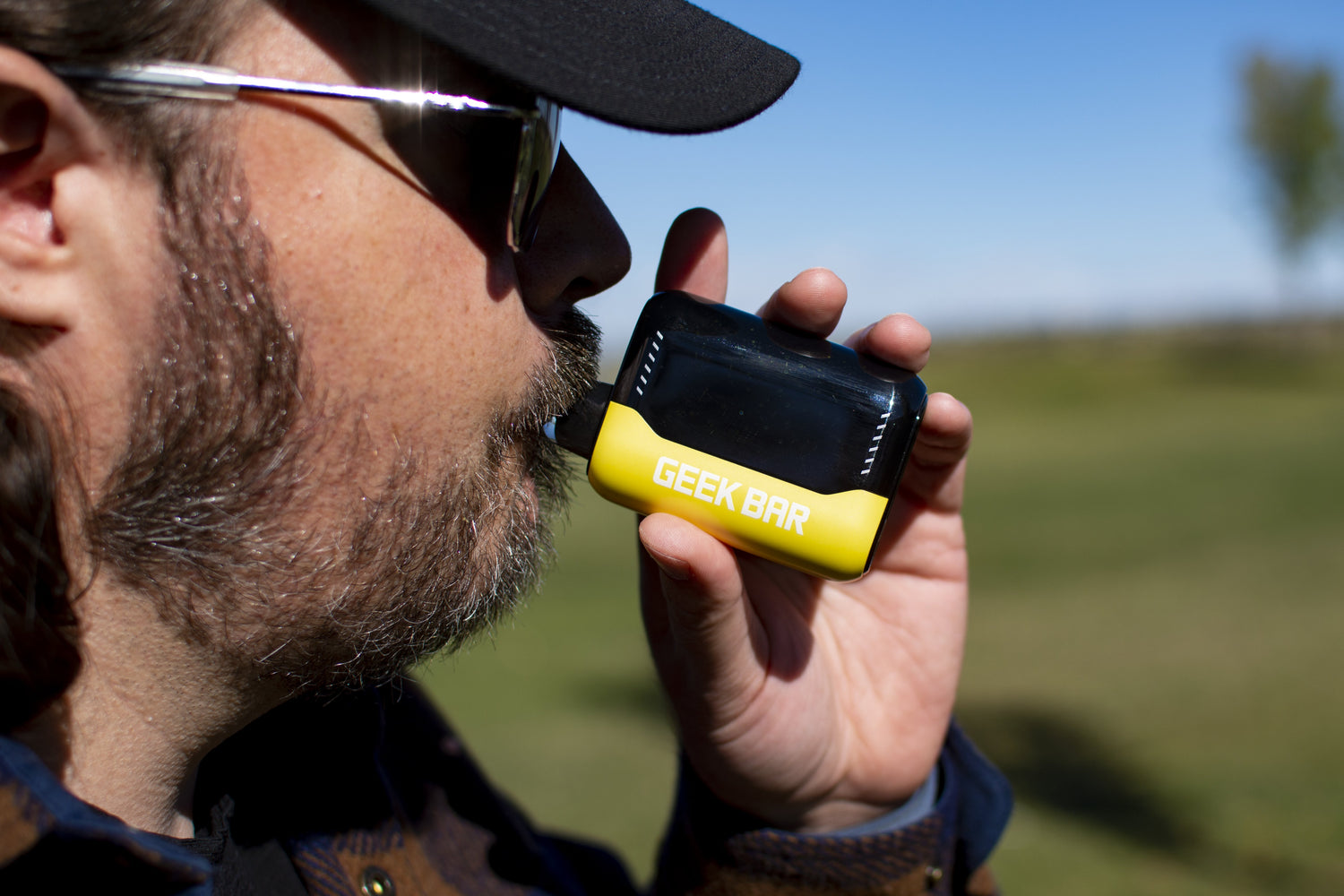 Man smoking yellow and black Geek Bar Pulse X outside 