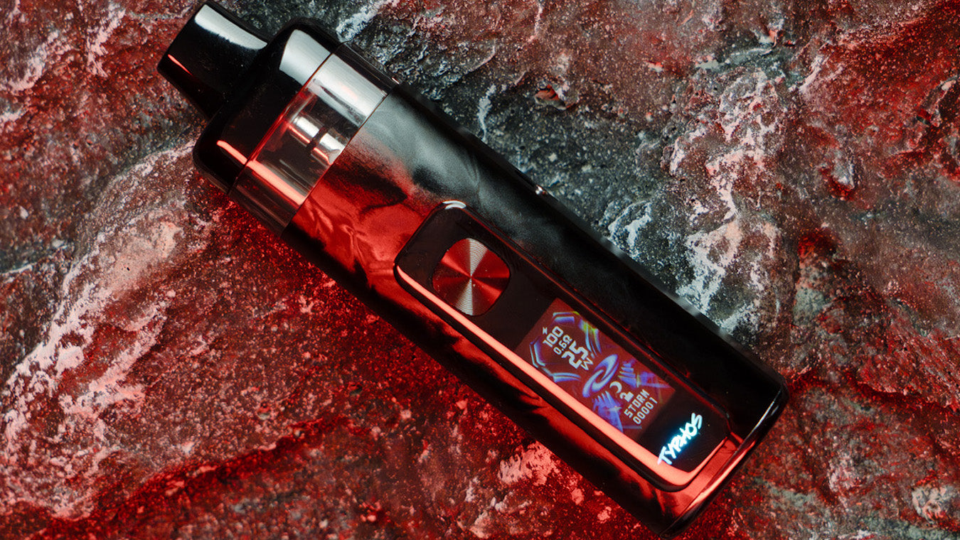 UWell Typhos vape device in Polar Black lying on a rocky background under red light with LED display lit