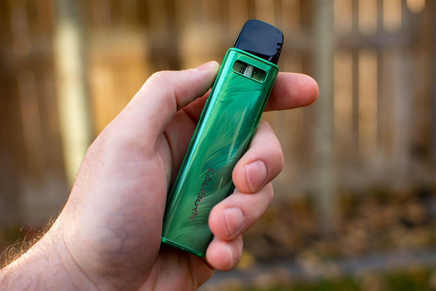 Person holding up a green UWell Caliburn G3 Pro