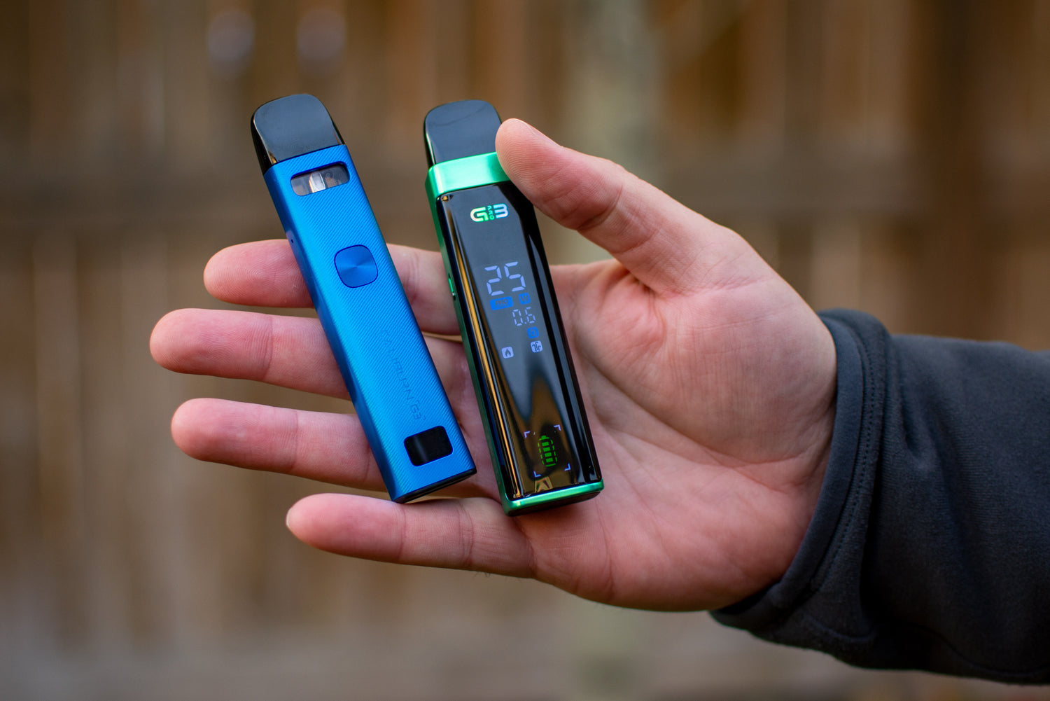 Person holding up a blue and green UWell Caliburn G3 Pro